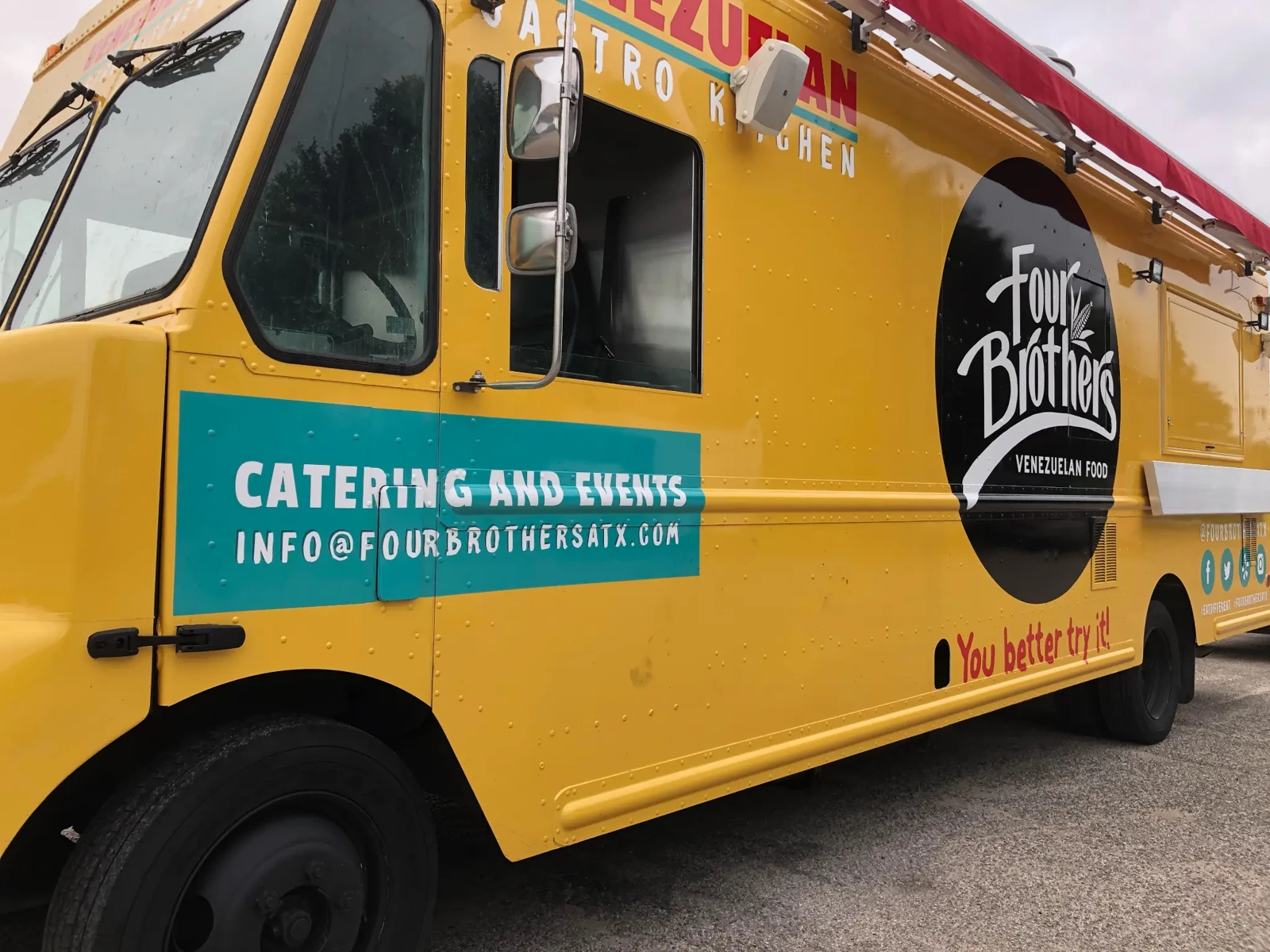 The yellow Four Brothers truck added in 2022, with a teal catering-and-events panel and a red awning.